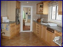 Kitchen showing door through to sunroom/conservatory.